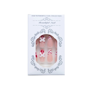 Pink almond press-on nails with cherry patterns, white bows, and pearls in a box