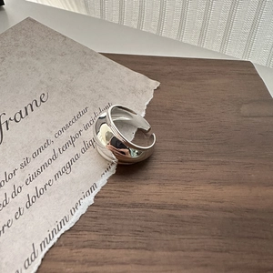 Minimalist wide band S925 sterling silver open ring on a vintage wooden surface