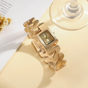 Detailed close-up of a luxury gold-tone women's bracelet watch with unique geometric links