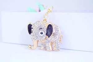 Detail of creative golden elephant keychain encrusted with sparkling rhinestones on gift box