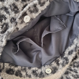 Detail view of the leopard faux shearling tote bag interior with dual pockets and magnetic clips
