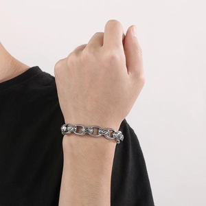 Vintage stainless steel chain bracelet with engraved ethnic patterns for men worn on wrist