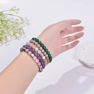 Natural 8mm stone beaded bracelet set with malachite and quartz on female wrist