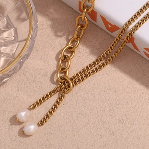 Close-up of gold plated stainless steel double chain with two Baroque pearls