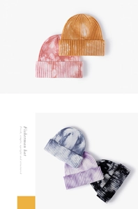 Detail of ribbed knit tie-dye beanie hats in various colors with a folded cuff design
