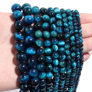 Detailed view of polished blue tiger eye stone beads with natural chatoyant effect