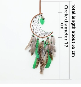 Detail of moon-shaped woven dreamcatcher with natural brown and green feathers