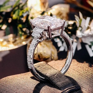 Macro shot of square emerald cut zircon center stone with side diamond inlay on silver ring