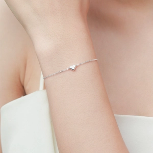 Minimalist S925 sterling silver heart pendant bracelet on woman wrist with delicate chain
