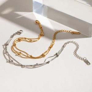 Layered stainless steel snake chain bracelet with metal beads in gold and silver finish