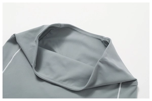 Detailed macro of high-waisted gray yoga shorts featuring white flatlock stitching