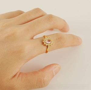 Close-up of adjustable sunflower ring with pink oval zircon and 18K gold finish