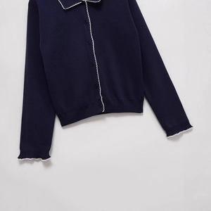 Navy blue knit cardigan with white scalloped trim edges and dark buttons for women