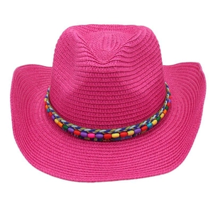 Detail of hot pink woven straw cowboy hat with colorful ethnic beaded decorative band