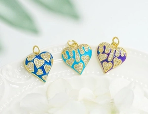 Detailed view of 18K gold plated heart charms with drip oil enamel and micro zircons