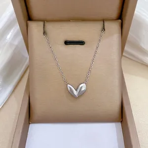 Minimalist silver leaf heart pendant necklace displayed in premium jewelry box