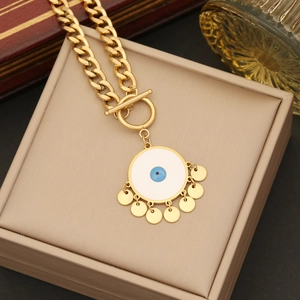 Detail of gold evil eye pendant with blue resin and dangling discs on chunky chain