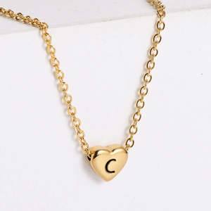 Detailed view of an 18k gold plated heart pendant necklace featuring an engraved letter C