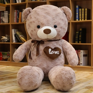 Detail of rose embossed plush fabric on teddy bear with silk bow and love patch
