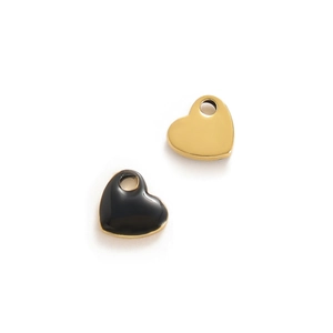 Close-up of gold and black enamel heart-shaped charms for DIY jewelry making