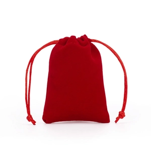 Single red velvet drawstring gift bag for jewelry storage on white background