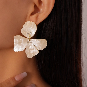 Close-up of model wearing retro resin flower earrings with delicate diamond inlay