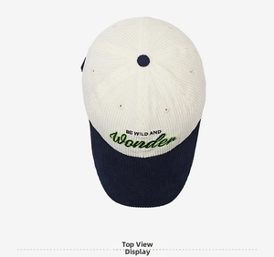 Detail view of corduroy baseball cap with WONDER embroidery and color blocking