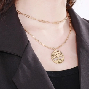 Detail of a double-layered gold tree of life necklace on a paperclip chain and model