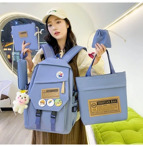 Blue nylon multi-piece student backpack set including handbags and plush bear charm