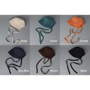 Breathable knitted bucket hat with ties shown in six colors beige green orange navy coffee black