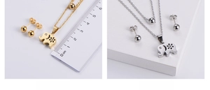 Detailed view of hollow elephant pendant necklace and ball stud earrings set