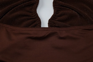 Close-up of ruched detail and glittery dark brown fabric on halter neck top