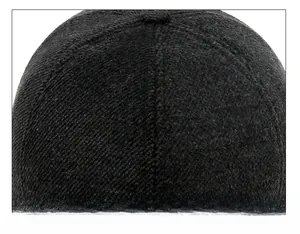 Detailed macro view of the six-panel crown stitching on a thick wool blend baseball cap