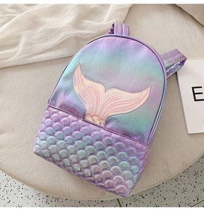 Detail of laser leather mermaid backpack showing pink tail embroidery and scale texture