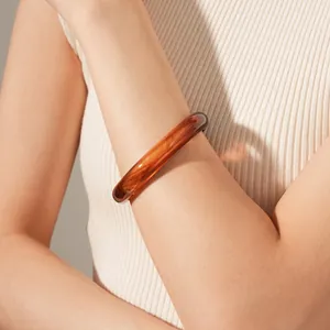 Minimalist amber resin bangle with vintage tortoiseshell texture and glossy finish