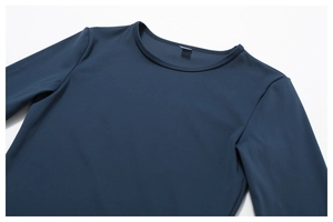 Detail of reinforced crew neck and premium stitching on navy long sleeve yoga top