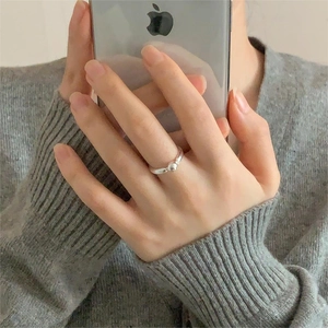 Close-up of minimalist 925 silver beaded ring on finger with polished sphere detail