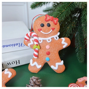 Close-up of gingerbread man Christmas ornament with detailed icing on green table