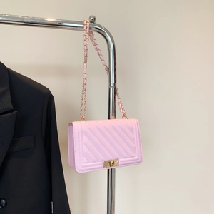 Detailed macro of pink quilted faux leather bag with golden metallic twist lock closure