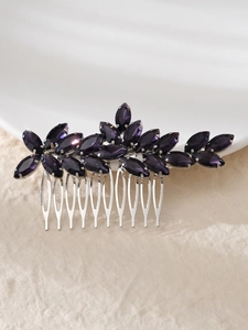 Detail of silver hair comb featuring deep purple marquise crystals in leaf design