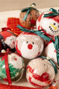 Detail of Christmas fuzzy socks in round gift balls with Santa and reindeer motifs