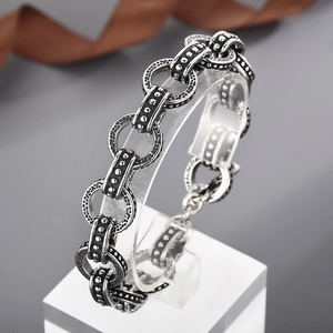 Detailed view of antique silver pig nose chain bracelet with textured metal links