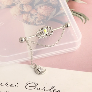 Detailed shot of lotus industrial piercing bar with rainbow gem and moon star chain
