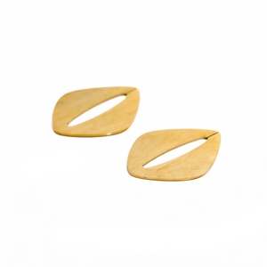 Detail of gold-plated leaf earrings with matte brushed texture on white background