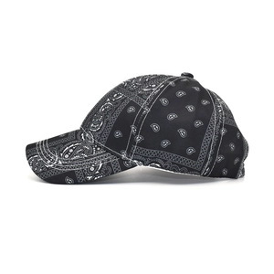 Side view of black and white paisley print baseball cap showing cotton twill texture