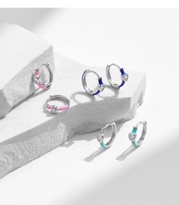 Close-up of S925 silver hoop earrings with pink and blue enamel and heart zircon stones
