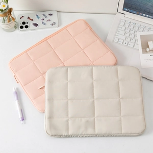 Sleek quilted 14-inch laptop sleeve in pink and beige colors for stylish protection