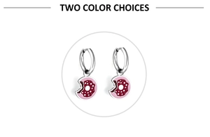 Detail showing doughnut-shaped earrings in pink and silver finish on a white background