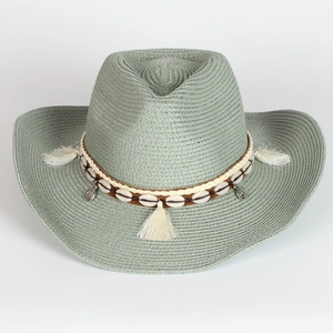 Detail of grey-green straw cowboy hat with shell trim and tassel on white background