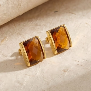 Detail of amber faceted rectangular glass earrings with elegant 18K gold plated base